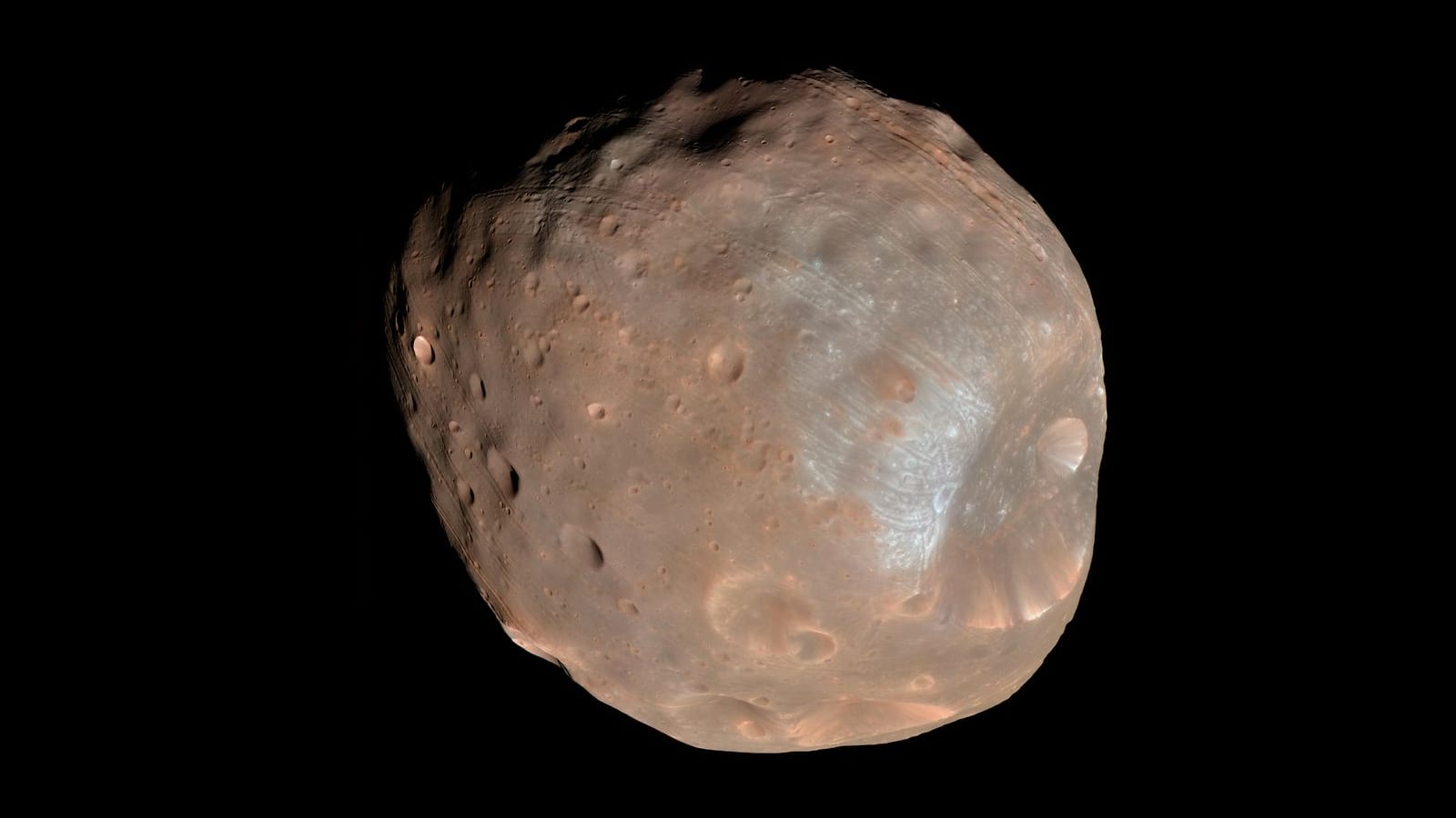 Phobos, a lumpy, cratered moon, against black space